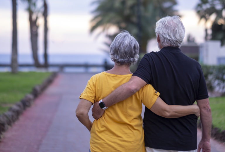 Two senior people walking happy